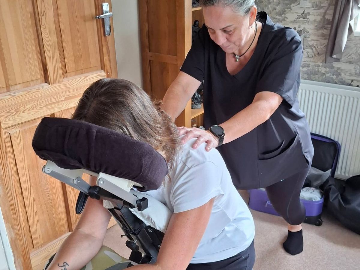 Seated Chair Massage — Pauline treating a client in a massage chair indoors
