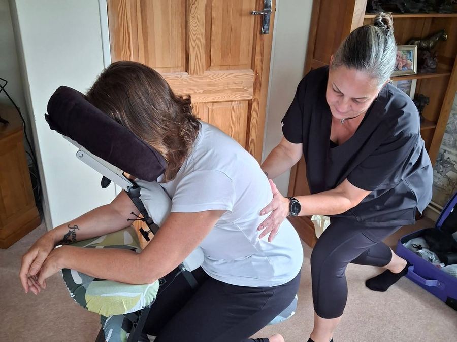 Seated Chair Massage — Pauline working on a client's lower back